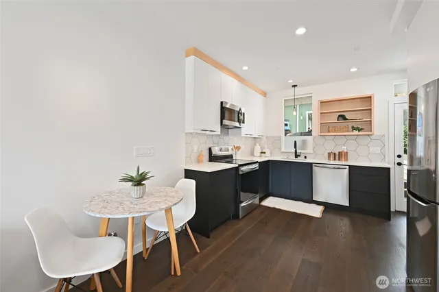 a kitchen with a sink cabinets and wooden floor