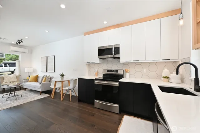 a kitchen with stainless steel appliances a stove sink microwave and cabinets