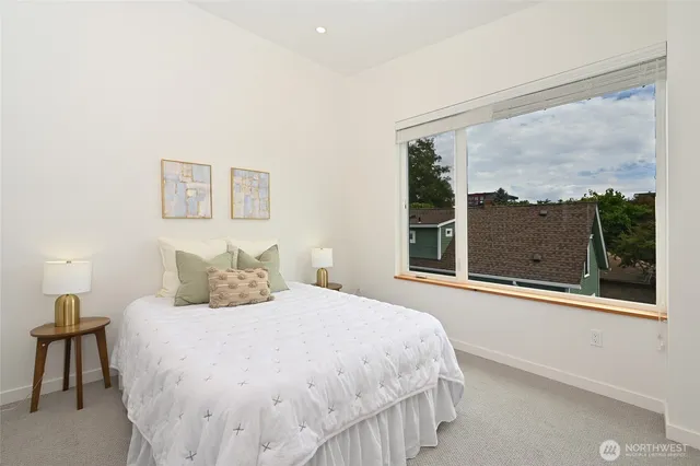 a bedroom with a large bed and a large window