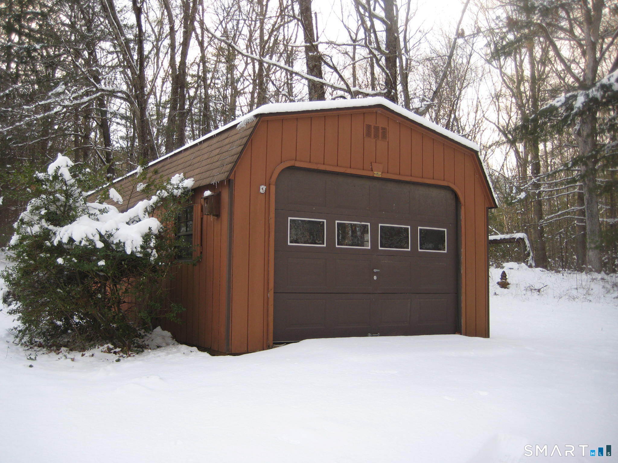 645 Buff Cap Road Tolland, CT 06084 - Photo 2 of 10 a front view of a house with a yard covered in snow