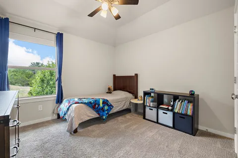 a bedroom with a bed and a large window