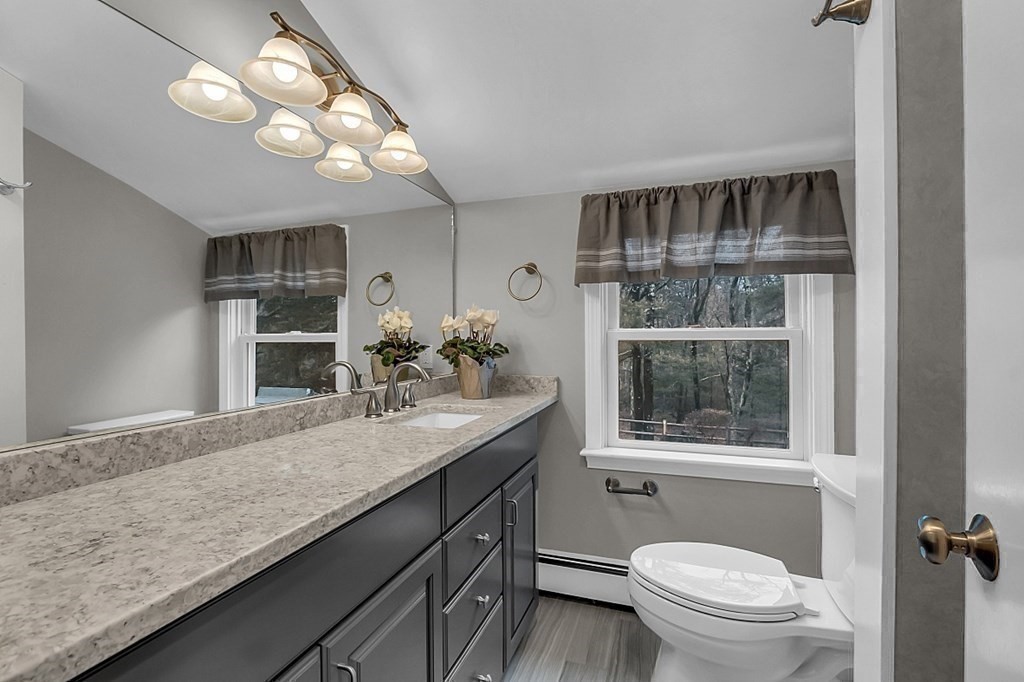 8 Springhill Road Wayland, MA 01778 - Photo 23 of 44 a bathroom with a granite countertop sink a toilet and a mirror