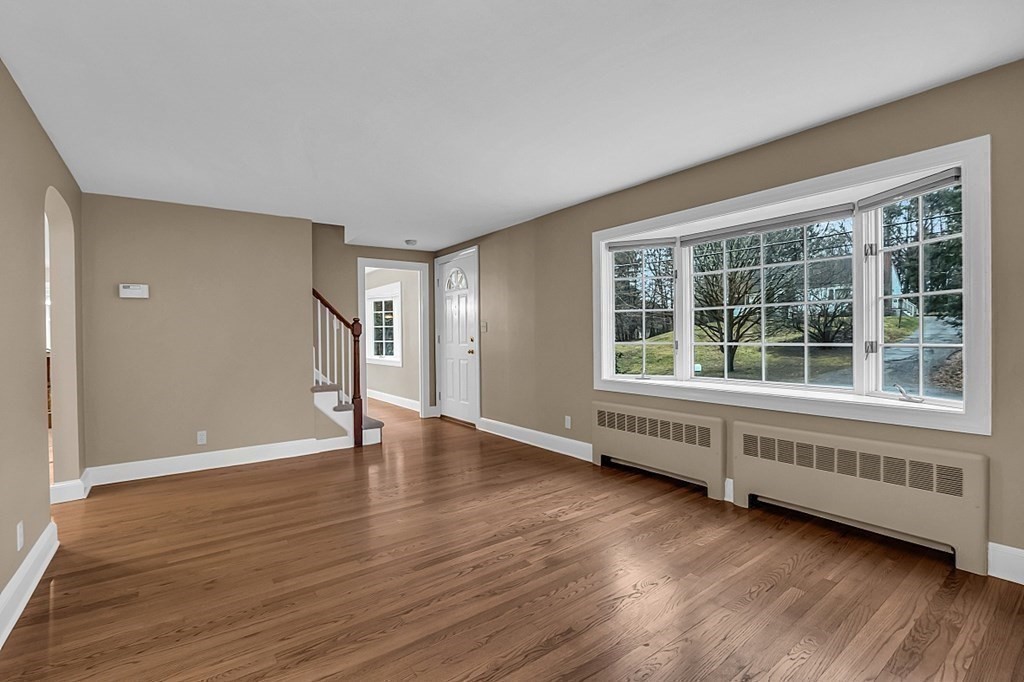 8 Springhill Road Wayland, MA 01778 - Photo 34 of 44 a view of an empty room with wooden floor and windows