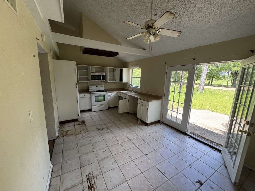 6133 Inca Drive Mabank, TX 75156 - Photo 7 of 10 a large white kitchen with a large window