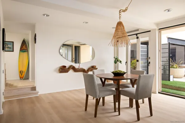 a dining room with furniture and wooden floor