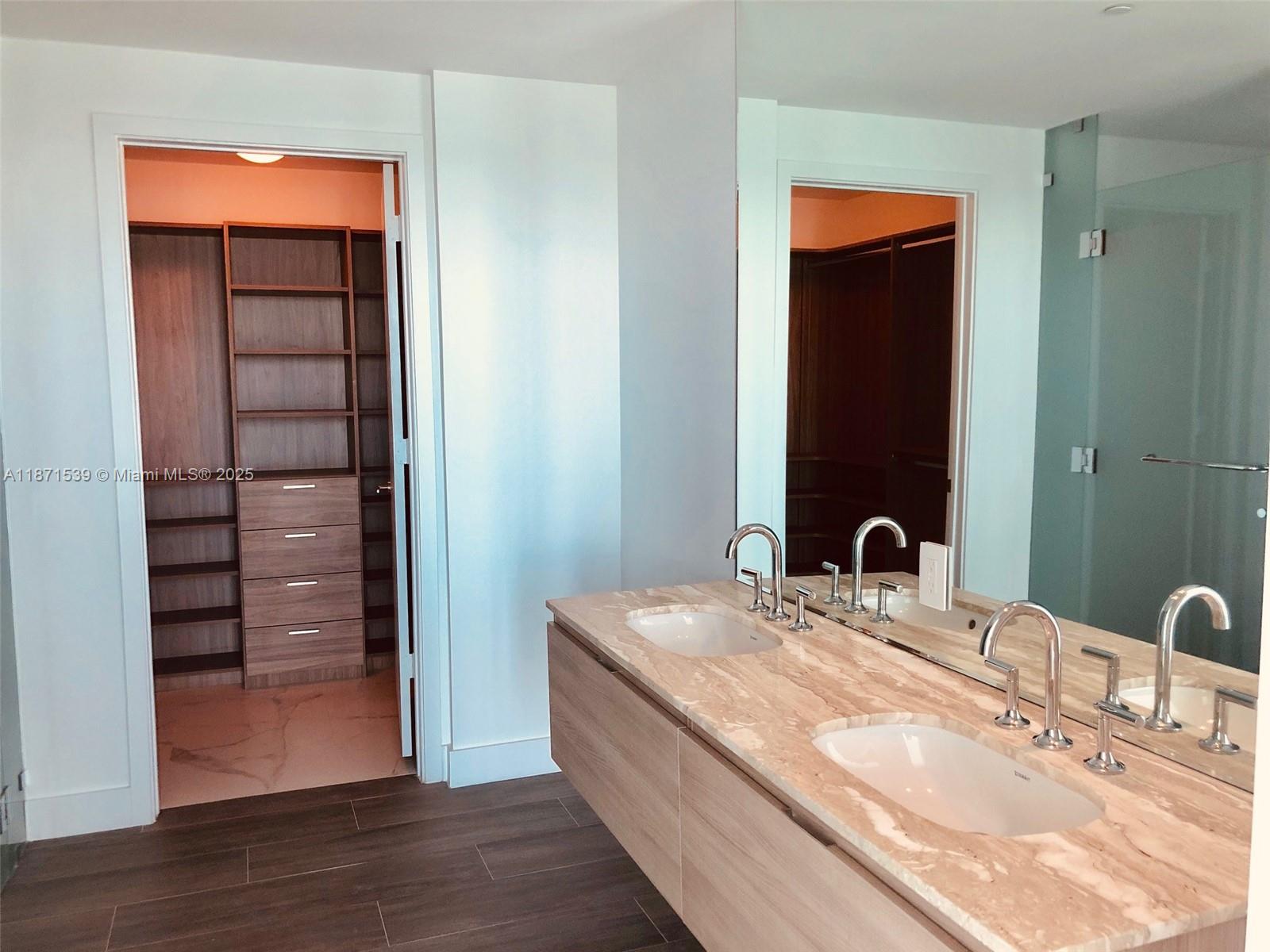 2900 Northeast 7th Avenue, Unit 2404 Miami, FL 33137 - Photo 11 of 42 a en suite bathroom with a granite countertop sink and a mirror