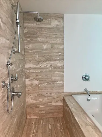 a bathroom with a granite countertop sink a toilet and shower