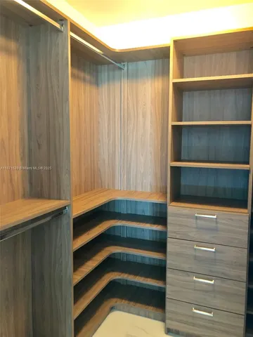 a view of room with window and cabinet