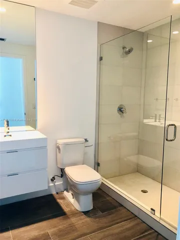 a bathroom with a toilet and a shower