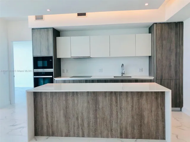 a kitchen with stainless steel appliances a refrigerator and sink