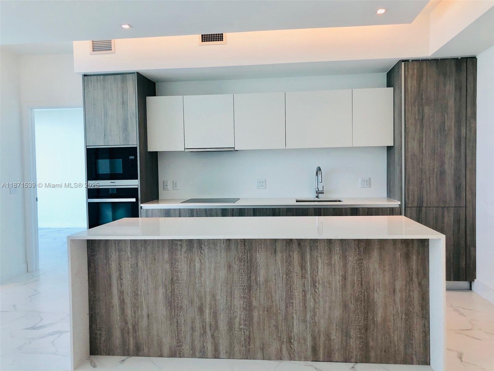 2900 Northeast 7th Avenue, Unit 2404 Miami, FL 33137 - Photo 2 of 42 a kitchen with stainless steel appliances a refrigerator and sink