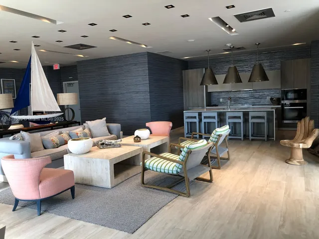 a living room with furniture and kitchen