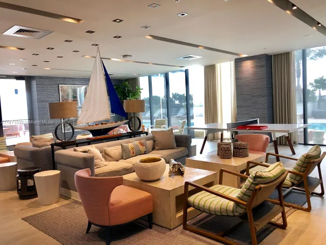 a living room with furniture and large windows