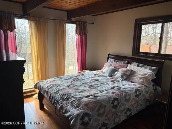 a bed sitting in a bedroom next to a window