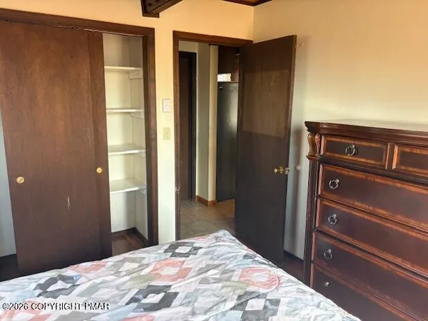 a bedroom with a bed and a dresser