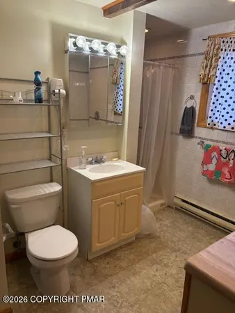 a bathroom with a toilet sink and shower