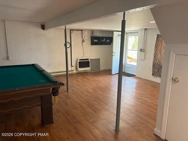 a open kitchen with window and wooden floor