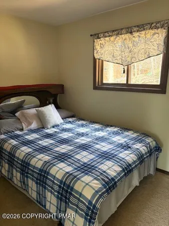 a bedroom with a bed and window
