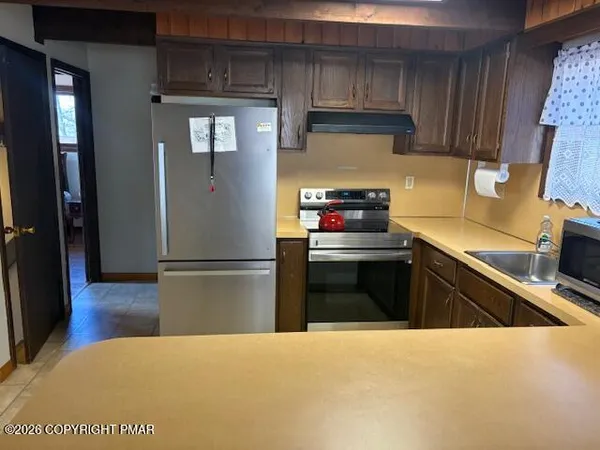 a kitchen with a refrigerator and a stove