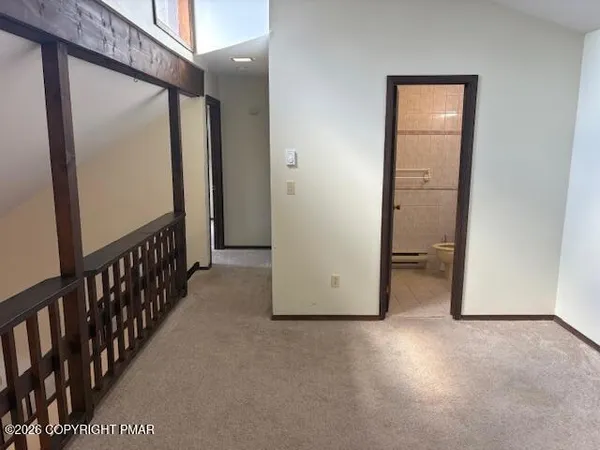 a view of a hallway with wooden floor and entryway