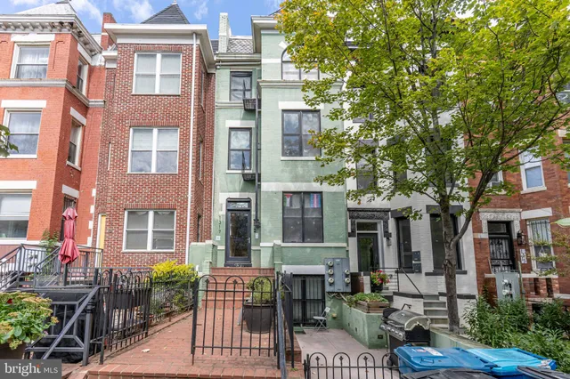 a front view of a building with outdoor seating