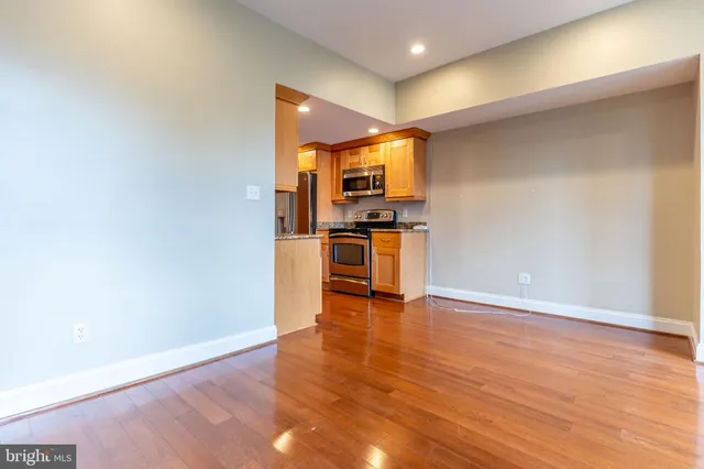 a view of a kitchen with a sink and a refrigerator
