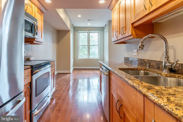 a kitchen with granite countertop a stove and a sink