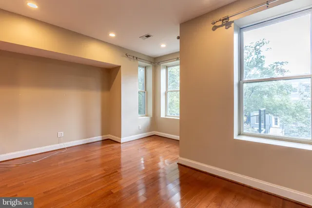 a view of room with window and wooden floor