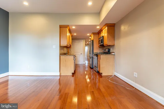a view of a living room with wooden floor