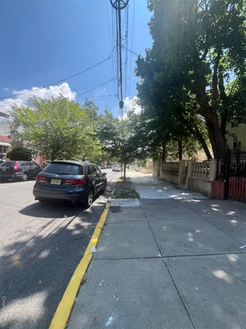 a view of a street that has a car parked on the road