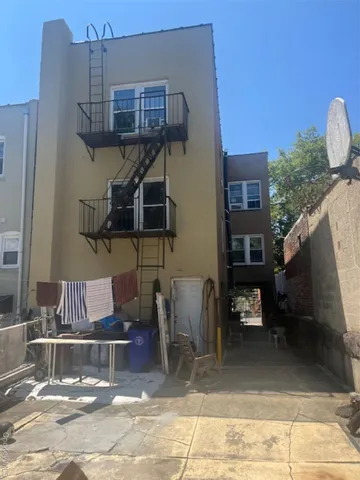 a view of a patio with table and chairs with wooden floor and fence