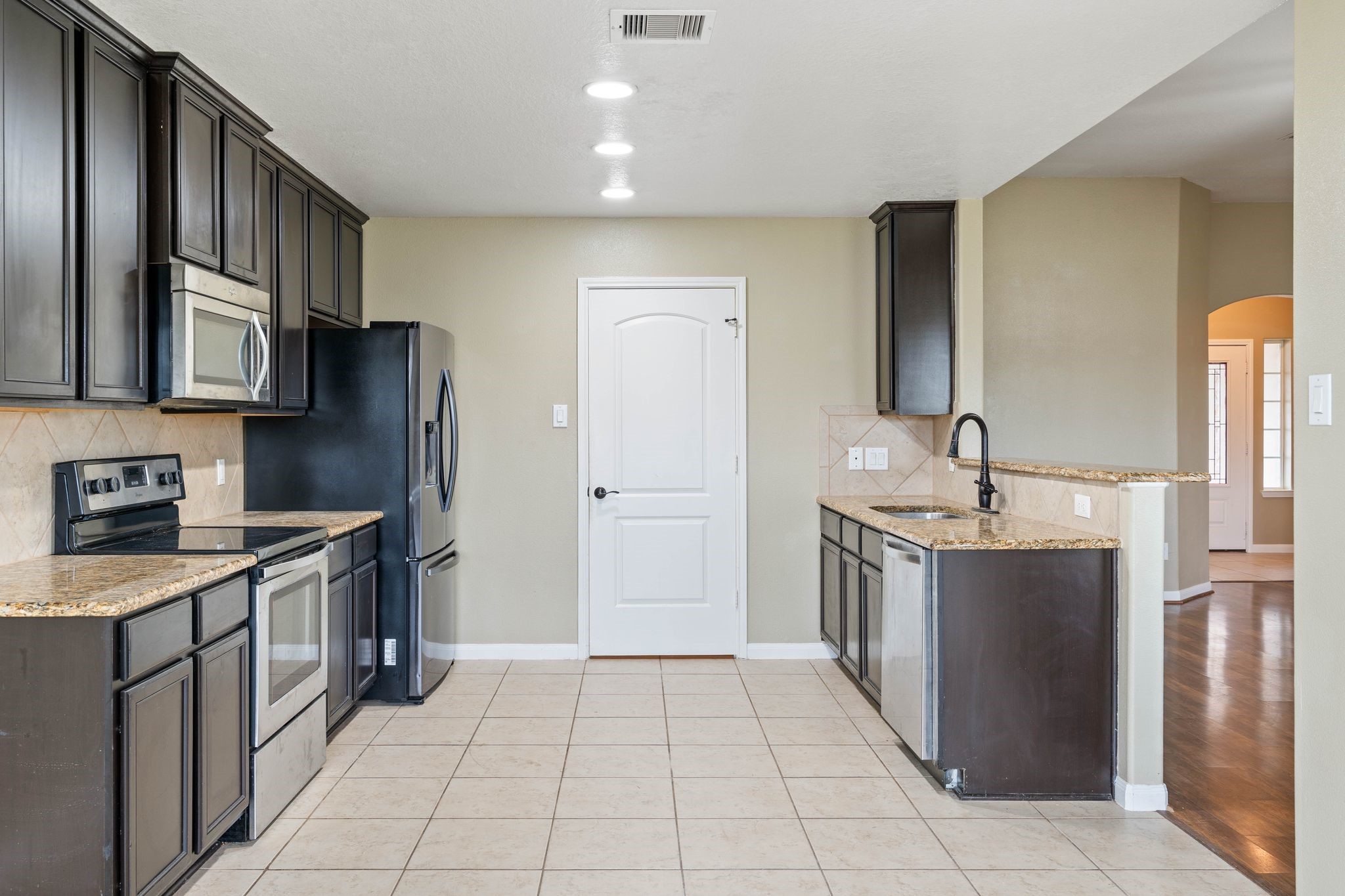 18875 Maverick Ranch Road East Magnolia, TX 77355 - Photo 15 of 45 a kitchen with stainless steel appliances granite countertop a refrigerator and a stove top oven