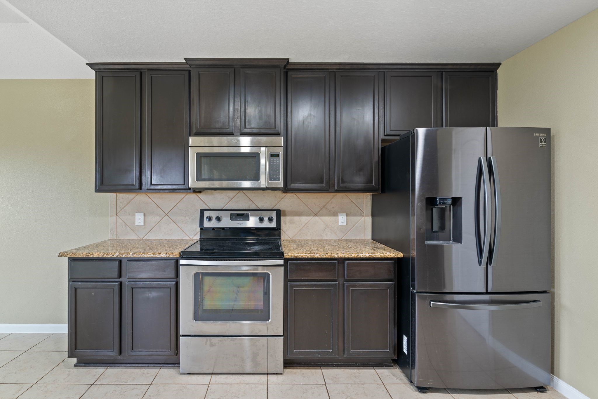 18875 Maverick Ranch Road East Magnolia, TX 77355 - Photo 16 of 45 a kitchen with stainless steel appliances granite countertop a refrigerator stove and microwave