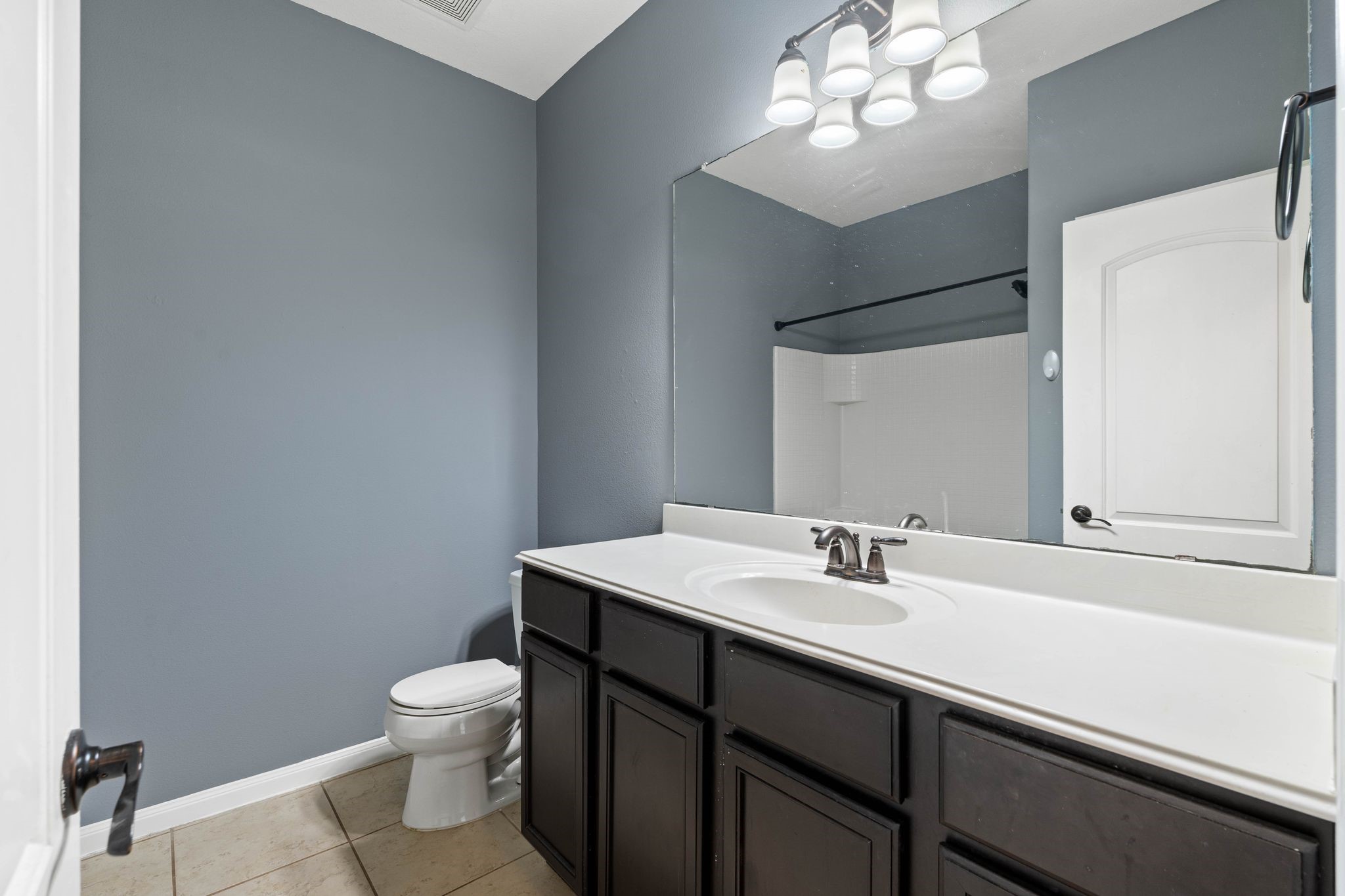 18875 Maverick Ranch Road East Magnolia, TX 77355 - Photo 31 of 45 a bathroom with a sink a toilet a mirror and shower