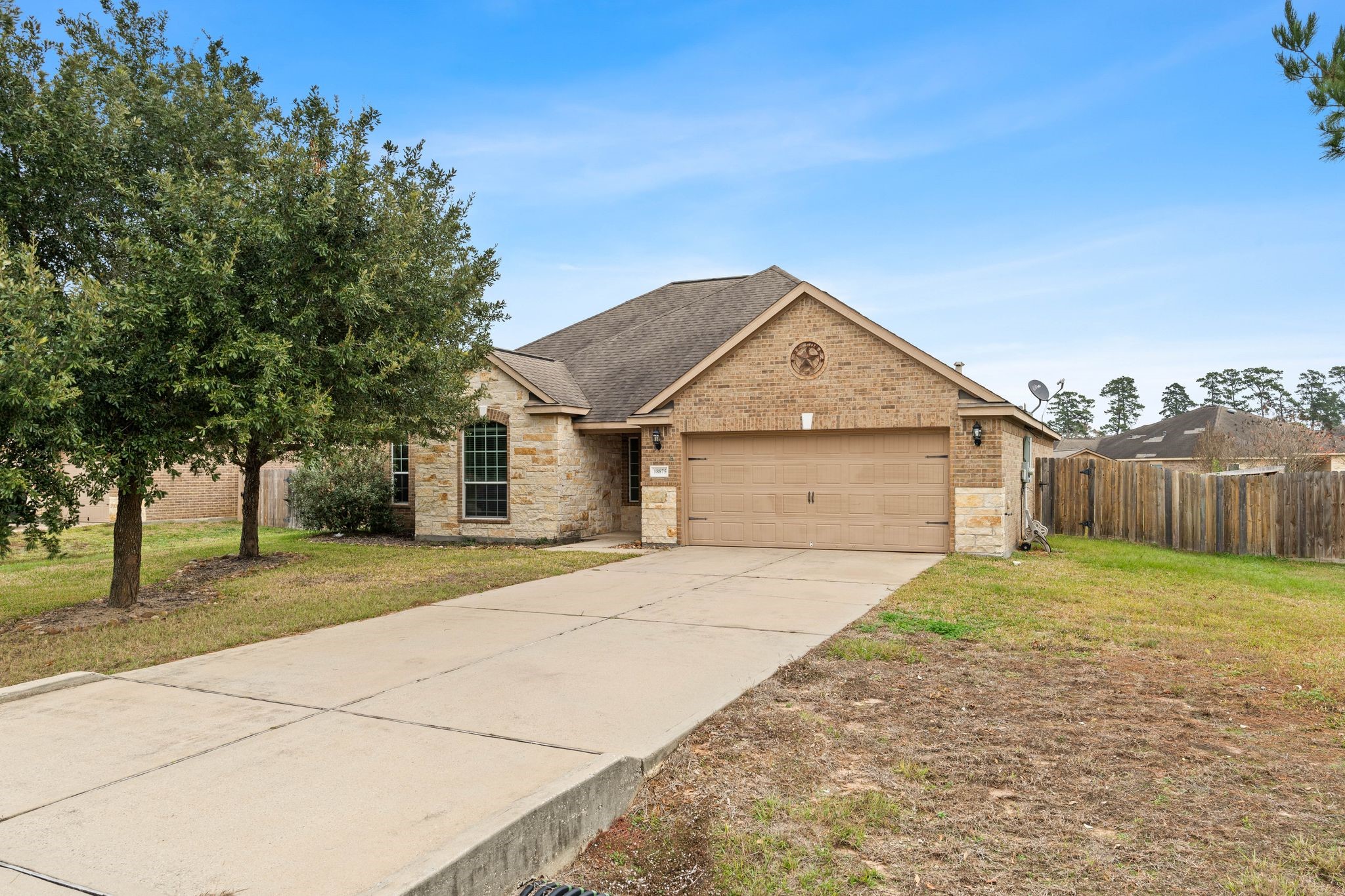 18875 Maverick Ranch Road East Magnolia, TX 77355 - Photo 42 of 45 a front view of a house with a yard and garage