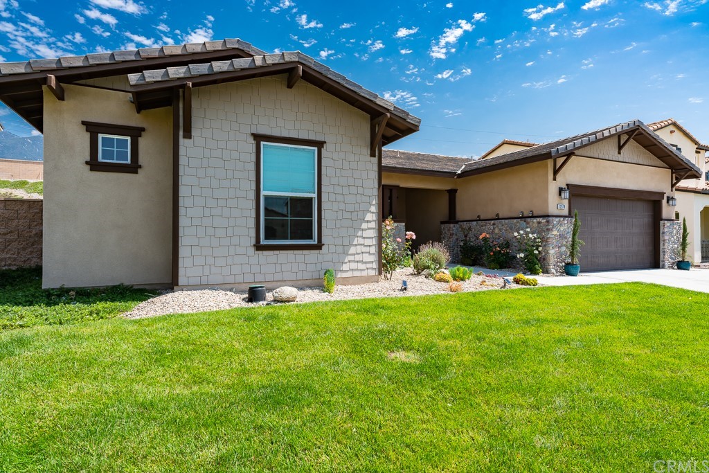 12370 Alamo Drive Rancho Cucamonga, CA 91739 - Photo 2 of 47 a front view of a house with a yard and garage
