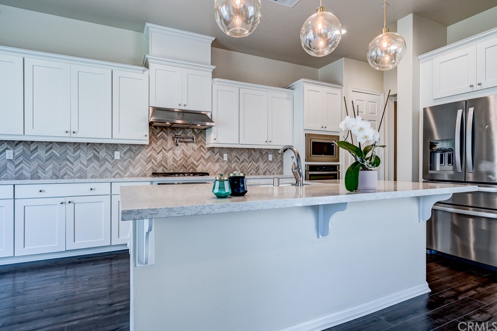 12370 Alamo Drive Rancho Cucamonga, CA 91739 - Photo 15 of 47 a kitchen with stainless steel appliances granite countertop a sink a stove and cabinets