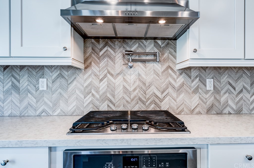 12370 Alamo Drive Rancho Cucamonga, CA 91739 - Photo 16 of 47 a stove top oven sitting inside of a kitchen