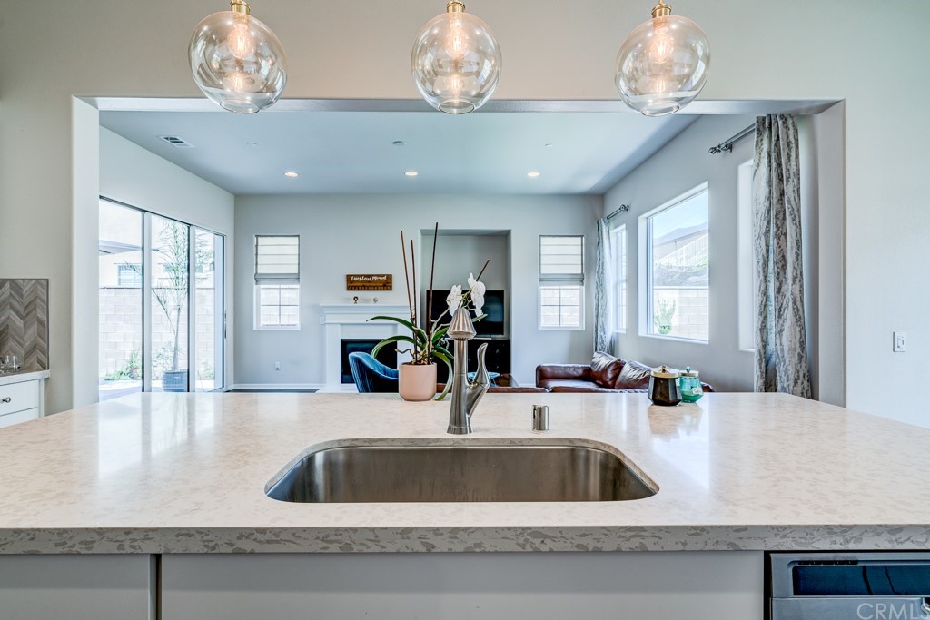 12370 Alamo Drive Rancho Cucamonga, CA 91739 - Photo 17 of 47 a kitchen with granite countertop a sink and a large mirror