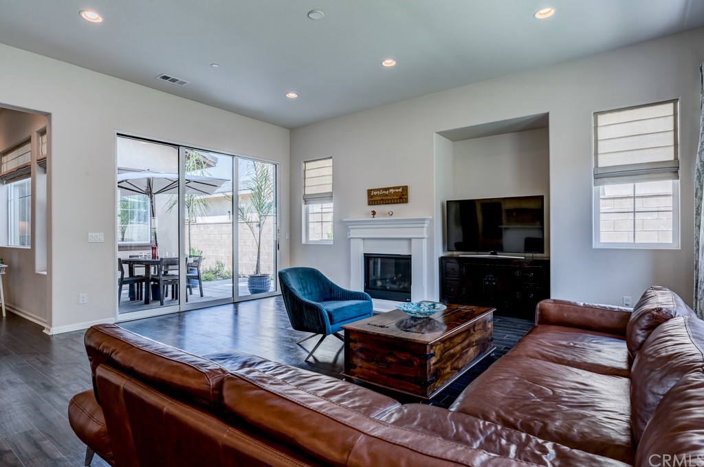12370 Alamo Drive Rancho Cucamonga, CA 91739 - Photo 21 of 47 a living room with furniture a table and a fireplace