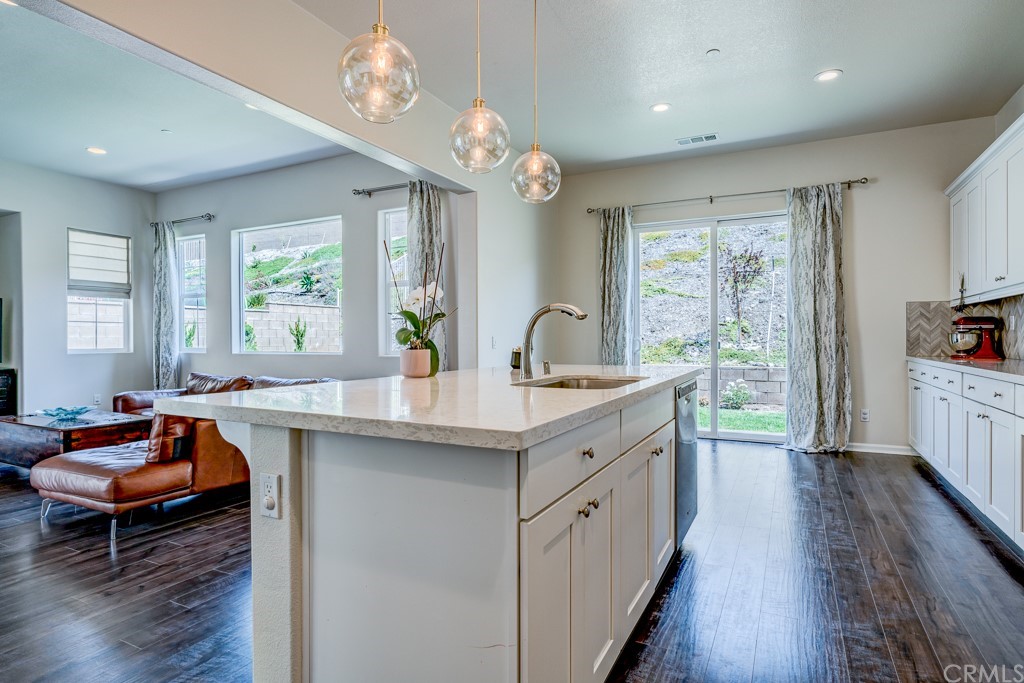 12370 Alamo Drive Rancho Cucamonga, CA 91739 - Photo 22 of 47 a kitchen with stainless steel appliances granite countertop a sink stove and wooden floor