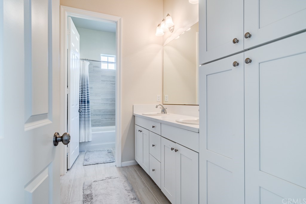 12370 Alamo Drive Rancho Cucamonga, CA 91739 - Photo 26 of 47 a bathroom with a double vanity sink and mirror