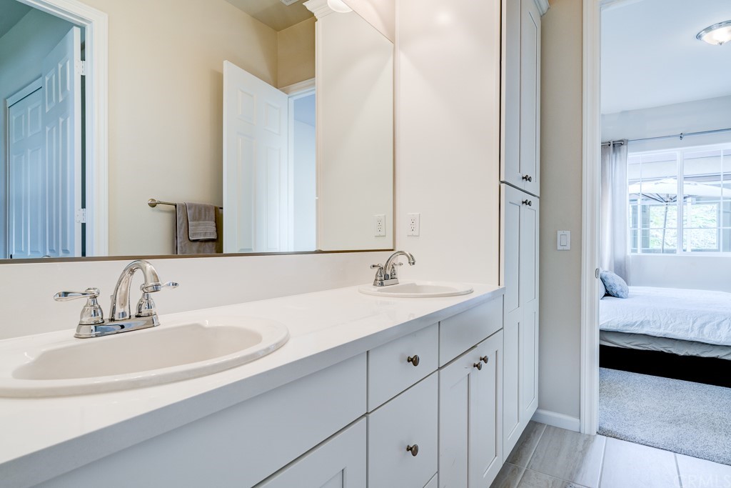 12370 Alamo Drive Rancho Cucamonga, CA 91739 - Photo 29 of 47 a en suite bathroom with a double vanity sink and a mirror