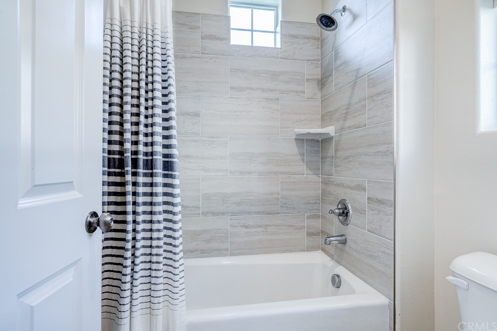 12370 Alamo Drive Rancho Cucamonga, CA 91739 - Photo 30 of 47 a bathroom with a bathtub and shower
