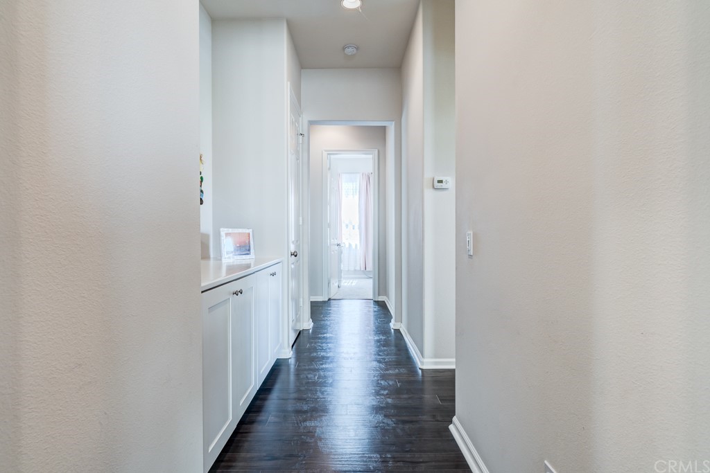 12370 Alamo Drive Rancho Cucamonga, CA 91739 - Photo 33 of 47 a view of a hallway with wooden floor