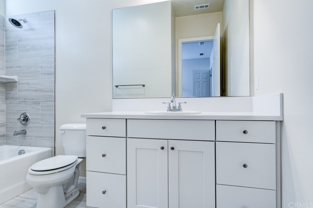 12370 Alamo Drive Rancho Cucamonga, CA 91739 - Photo 44 of 47 a bathroom with a sink a toilet and vanity