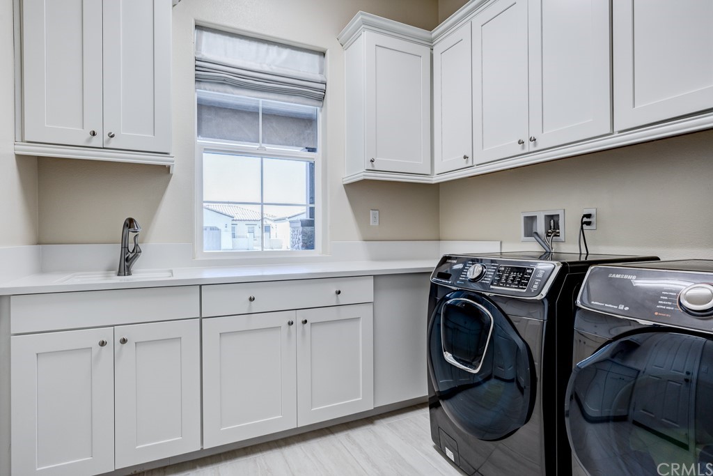 12370 Alamo Drive Rancho Cucamonga, CA 91739 - Photo 45 of 47 a utility room with cabinets dryer and washer