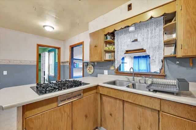 a kitchen with a sink and a stove top oven