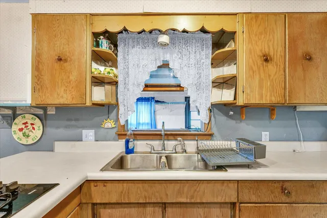 a kitchen with a sink and a stove