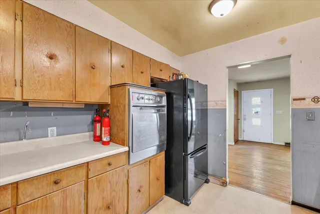 a kitchen with stainless steel appliances a refrigerator and sink